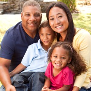 A diverse family with a young girl and boy