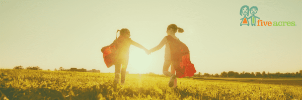 Children running in a sunny field
