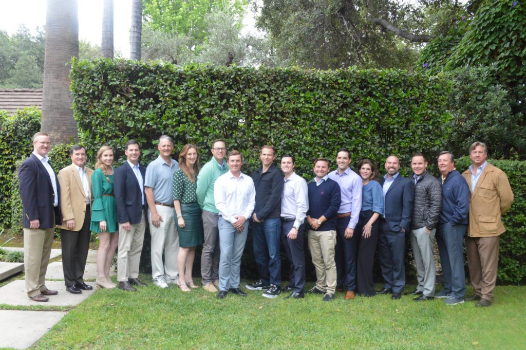 Outdoor group photo with hedge backdrop