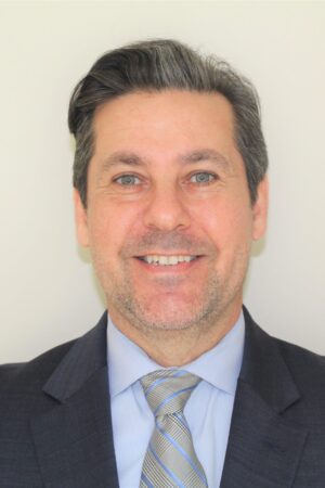 Professional headshot of a middle-aged man