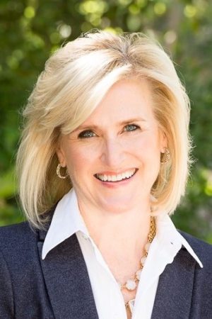 Happy woman in suit jacket and blouse