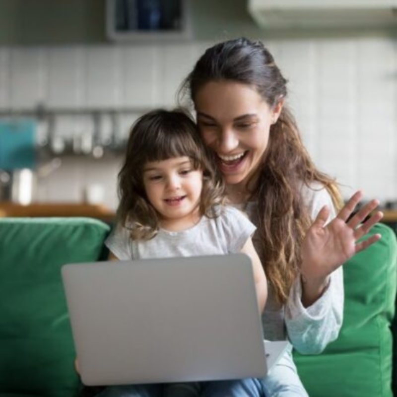 Woman and daughter waving at screen