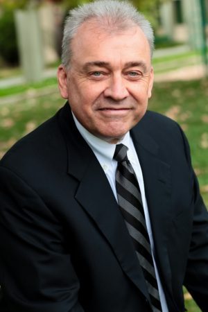 Man in suit smiling outdoors