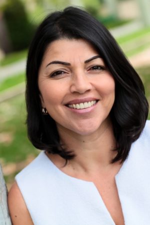 Smiling woman outdoors with dark hair